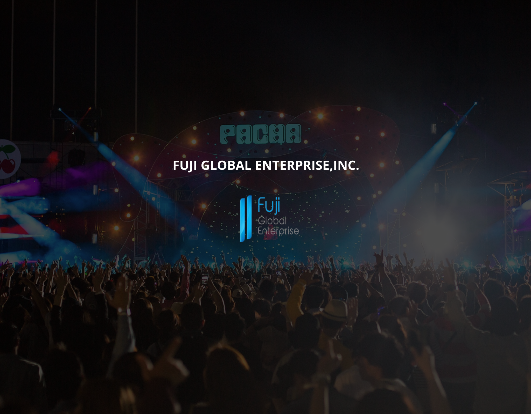 Fuji Global Enterprise, Inc. at a Pacha festival, with a brightly lit stage and a crowd of music fans
